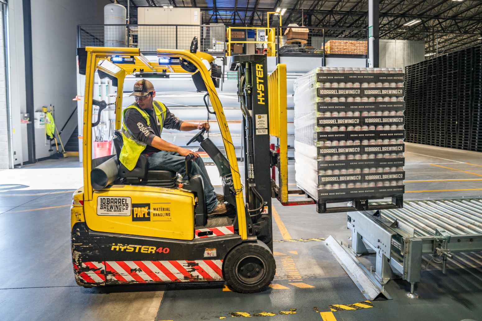 Forklift moving pallet in warehouse